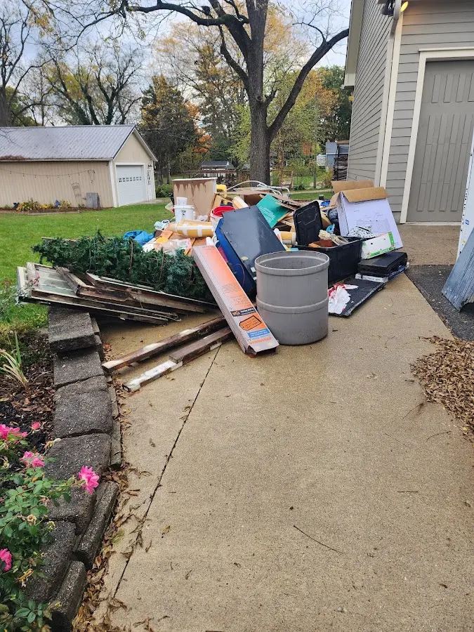 Dumpster being loaded with debris for Estate Cleanout Dumpster Rental in Minoa